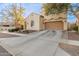 Two-story house with tan exterior, red-tiled accents, and a two-car garage at 13608 N 150Th Ln, Surprise, AZ 85379