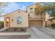 Two-story house with tan exterior, red-tiled accents, and a two-car garage at 13608 N 150Th Ln, Surprise, AZ 85379