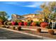 Charming two-story home featuring a tile roof, solar panels, and lush landscaping with vibrant bougainvillea bushes at 13608 N 150Th Ln, Surprise, AZ 85379