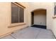 Front entry with arched doorway, red tile accents, and a wrought-iron gate at 13608 N 150Th Ln, Surprise, AZ 85379