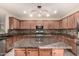 Island kitchen with granite countertops and wood cabinets at 13608 N 150Th Ln, Surprise, AZ 85379