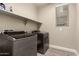 Laundry room with washer, dryer, and overhead shelving at 13608 N 150Th Ln, Surprise, AZ 85379