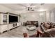 Gathering room with leather sofas, white media console and ceiling fan at 13608 N 150Th Ln, Surprise, AZ 85379