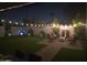 Landscaped backyard at night, string lights and fire pit at 14426 N 39Th Way, Phoenix, AZ 85032