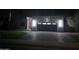 Illuminated home exterior at night featuring a modern design with brick driveway and eye-catching lighting at 14426 N 39Th Way, Phoenix, AZ 85032