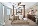 Elegant bedroom featuring a four-poster bed and a plush seating area at 15791 W Mohave St, Goodyear, AZ 85338