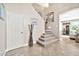 Elegant entryway with tiled floors, staircase, and coat closet at 15791 W Mohave St, Goodyear, AZ 85338