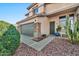 Front entry with a gray garage door and cacti at 15791 W Mohave St, Goodyear, AZ 85338