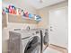 Bright laundry room, featuring Samsung washer and dryer, and ample shelving at 15791 W Mohave St, Goodyear, AZ 85338