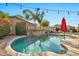 Inviting kidney-shaped pool with patio and string lights at 15791 W Mohave St, Goodyear, AZ 85338