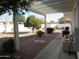 Covered patio, fruit tree, and gravel backyard at 16809 N Meadow Park Dr, Sun City, AZ 85351