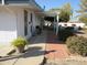 Covered patio, brick pavers, and lush landscaping create a relaxing outdoor space at 16809 N Meadow Park Dr, Sun City, AZ 85351