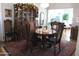 Elegant dining room, featuring a wooden table and display cabinet at 16809 N Meadow Park Dr, Sun City, AZ 85351