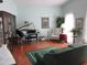 Spacious living room featuring hardwood floors and a grand piano at 16809 N Meadow Park Dr, Sun City, AZ 85351