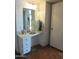 White vanity with drawers and a large mirror at 16809 N Meadow Park Dr, Sun City, AZ 85351