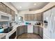 Bright kitchen featuring grey cabinetry, modern appliances and a breakfast bar overlooking the backyard at 17318 E Quail Ridge Dr, Fountain Hills, AZ 85268