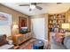 Cozy living room featuring built-in shelves, a ceiling fan, and an entertainment center at 17318 E Quail Ridge Dr, Fountain Hills, AZ 85268