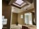 Bathroom with double sinks, soaking tub, and skylight at 17790 N 66Th Ln, Glendale, AZ 85308