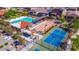 Aerial view of community amenities, including pool, shuffleboard, tennis courts, and seating areas at 18149 W Cielo Grande Ave, Surprise, AZ 85387