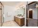 Elegant bathroom with dual vanity, granite countertop, and large mirror at 2 W Keim Dr, Phoenix, AZ 85013