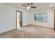 Bright bedroom with carpet flooring, ceiling fan, and window shutters at 2 W Keim Dr, Phoenix, AZ 85013