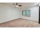 Spacious bedroom featuring carpet, a ceiling fan and large window at 2 W Keim Dr, Phoenix, AZ 85013