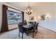 Elegant dining room features a large window, chandelier, and seating for six at 2 W Keim Dr, Phoenix, AZ 85013