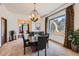 Formal dining room with dark wood table and large windows at 2 W Keim Dr, Phoenix, AZ 85013