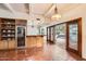 Modern kitchen with wood cabinetry, wine cooler, and terracotta flooring at 2 W Keim Dr, Phoenix, AZ 85013