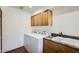 Convenient laundry room with washer, dryer, and upper cabinets at 2 W Keim Dr, Phoenix, AZ 85013