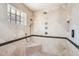 Walk-in shower with multiple shower heads and a built-in seat at 2 W Keim Dr, Phoenix, AZ 85013