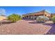 Landscaped backyard with gravel and desert plants at 20040 W Hunter Dr, Wittmann, AZ 85361