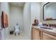 Clean bathroom with wood vanity and tiled accents at 20040 W Hunter Dr, Wittmann, AZ 85361