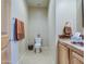 Small bathroom with tiled floors and wood vanity at 20040 W Hunter Dr, Wittmann, AZ 85361