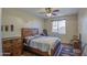 Cozy bedroom with wooden furniture, tile floors, and ceiling fan at 20040 W Hunter Dr, Wittmann, AZ 85361