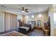 Primary bedroom with dark wood furniture and ceiling fan at 20040 W Hunter Dr, Wittmann, AZ 85361