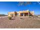 Southwest style home with three-car garage and desert landscaping at 20040 W Hunter Dr, Wittmann, AZ 85361