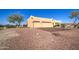 Attached three-car garage with light-colored stucco exterior at 20040 W Hunter Dr, Wittmann, AZ 85361