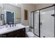 Bathroom with white vanity, brown cabinets, and a glass shower at 20473 W Park Meadows Dr, Buckeye, AZ 85396