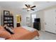 Bedroom with orange striped bedding, bookshelf, and en-suite bathroom at 20473 W Park Meadows Dr, Buckeye, AZ 85396