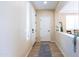 Light-colored entryway with tile flooring, white door, and neutral walls at 20473 W Park Meadows Dr, Buckeye, AZ 85396