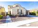 Two-story house with beige exterior, brown garage door, and landscaped front yard at 20473 W Park Meadows Dr, Buckeye, AZ 85396