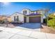 Two-story house with beige exterior, brown garage door, and landscaped front yard at 20473 W Park Meadows Dr, Buckeye, AZ 85396