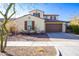 Two-story house with beige exterior, brown garage door, and landscaped front yard at 20473 W Park Meadows Dr, Buckeye, AZ 85396