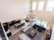 High-ceiling living room with chandelier and kitchen view at 20473 W Park Meadows Dr, Buckeye, AZ 85396