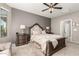 Comfortable bedroom featuring a king-size bed, nightstands and a ceiling fan at 21720 N 265Th Dr, Buckeye, AZ 85396