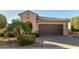 Tan two-story house with a brown garage door and palm trees in front at 21720 N 265Th Dr, Buckeye, AZ 85396