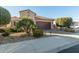 Two-story home with a brown garage door and nicely landscaped yard at 21720 N 265Th Dr, Buckeye, AZ 85396