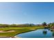 Scenic golf course with water features and mountain views at 21720 N 265Th Dr, Buckeye, AZ 85396