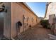 Home's exterior side showcasing utility hookups and garage at 21720 N 265Th Dr, Buckeye, AZ 85396